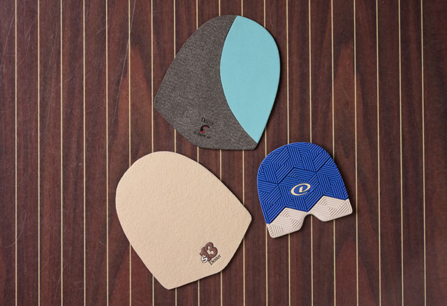 The Slide Pilot slide sole in Grey/Blue (Multicolor), The S13 Slide sole in white and the H1X traction heel in blue on a wood floor.